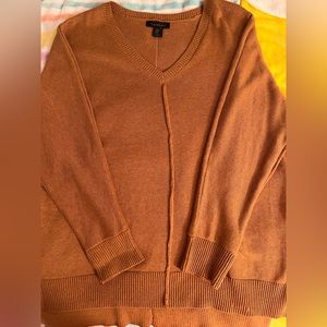 This is a cotton v-neck sweater. Light Brown in color